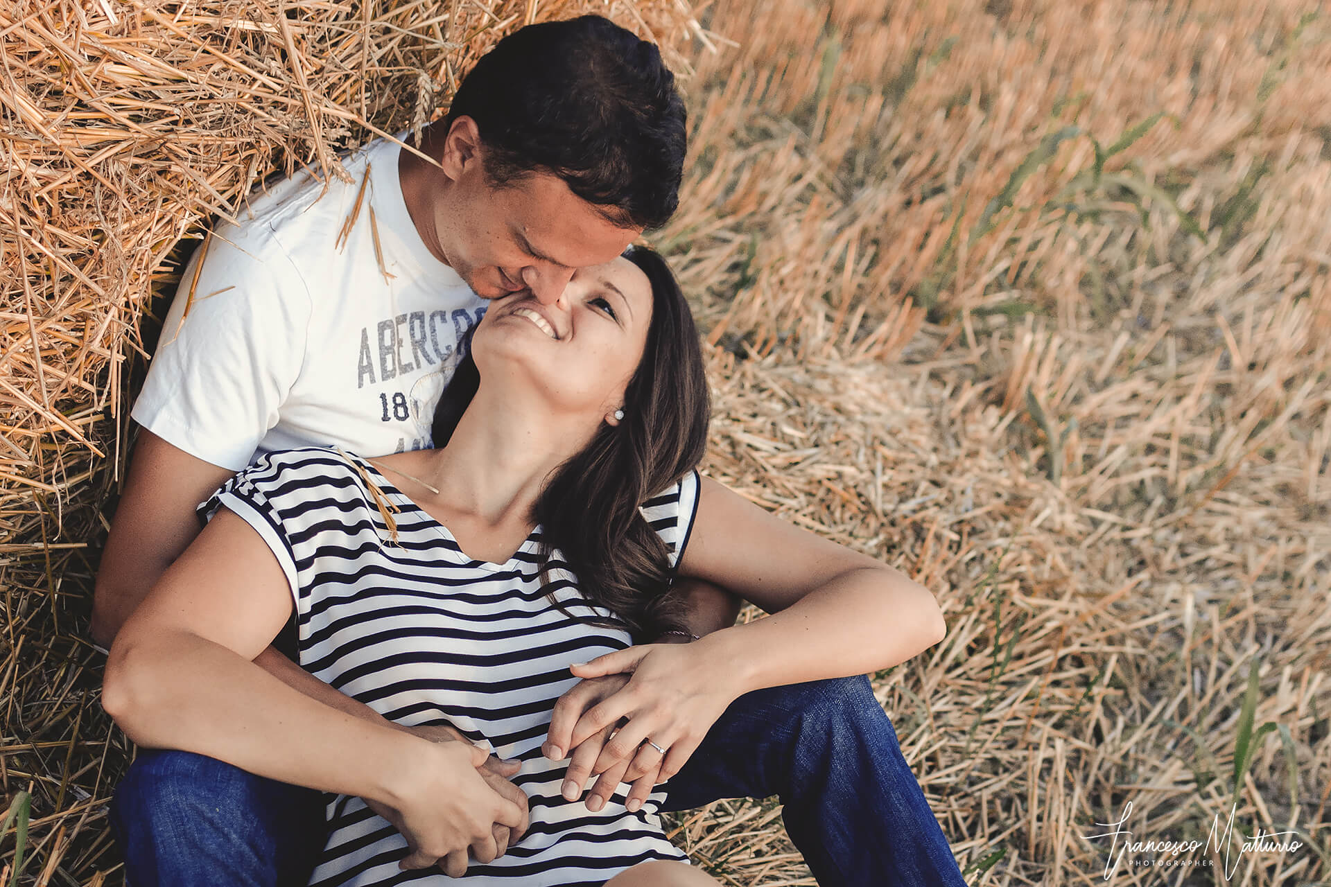 Servizio fotografico pre-matrimoniale di una coppia giovane in un campo di grano in estate ad Asti di Francesco Matturro